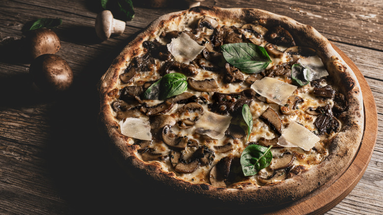 Mushroom pizza on a wooden table