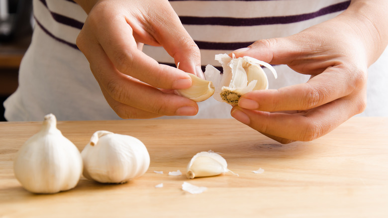 person peeling garlic