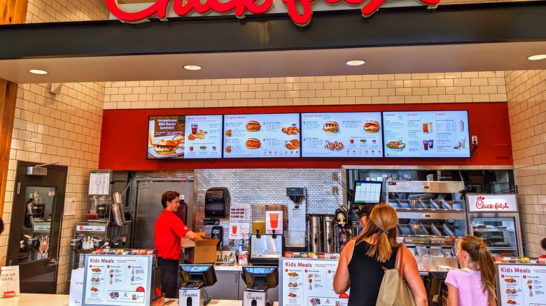 Two people look at the Chick-fil-A menu