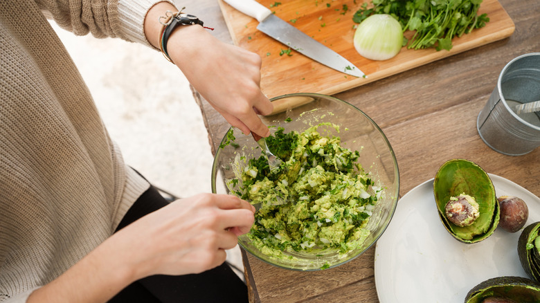 woman mashing guacamole 