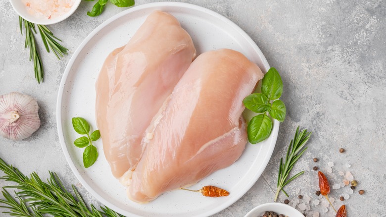 raw chicken breasts on plate