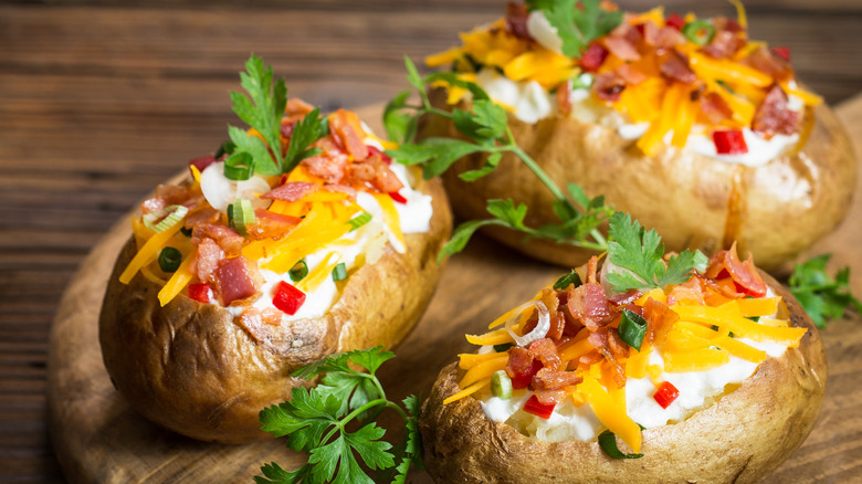 Loaded baked potatoes on board
