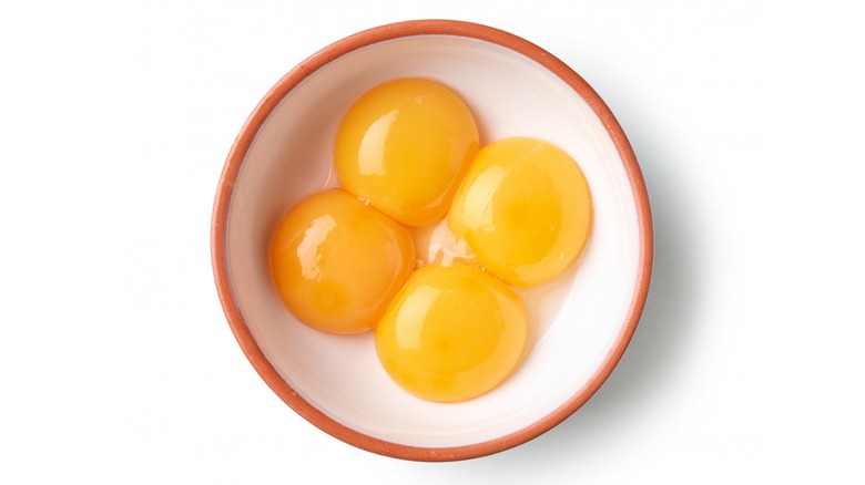 Four egg yolks in a bowl