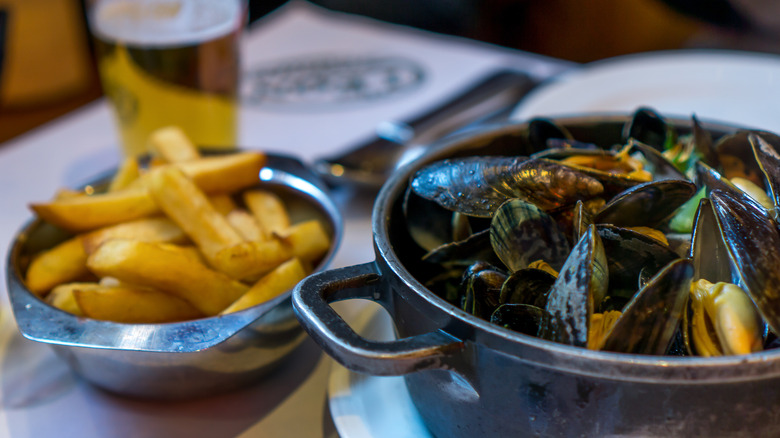 Bowl of mussels with fries and beer