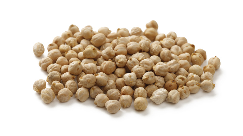 Pile of dry chickpeas against white background