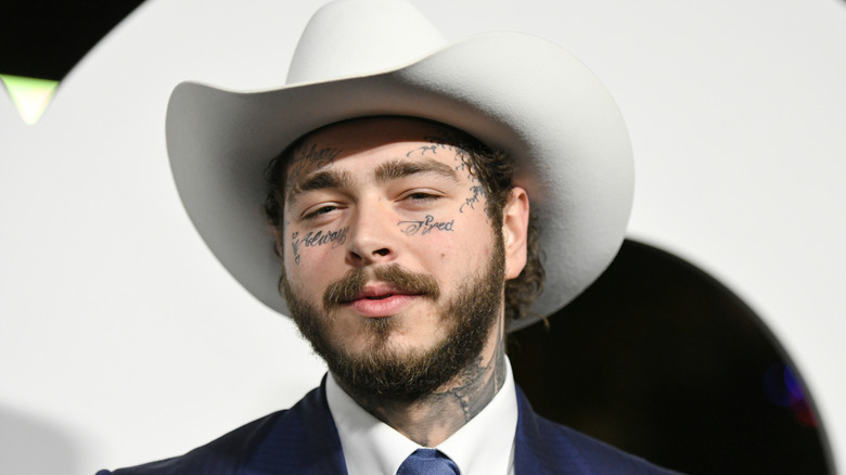 Post Malone in white cowboy hat at event