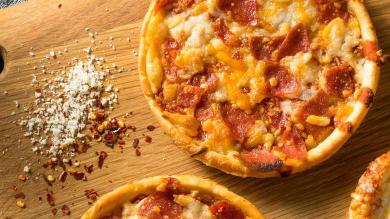 Frozen pizza on cutting board
