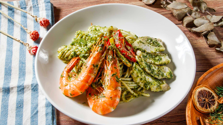 Pesto pasta with shrimp and grilled fish.