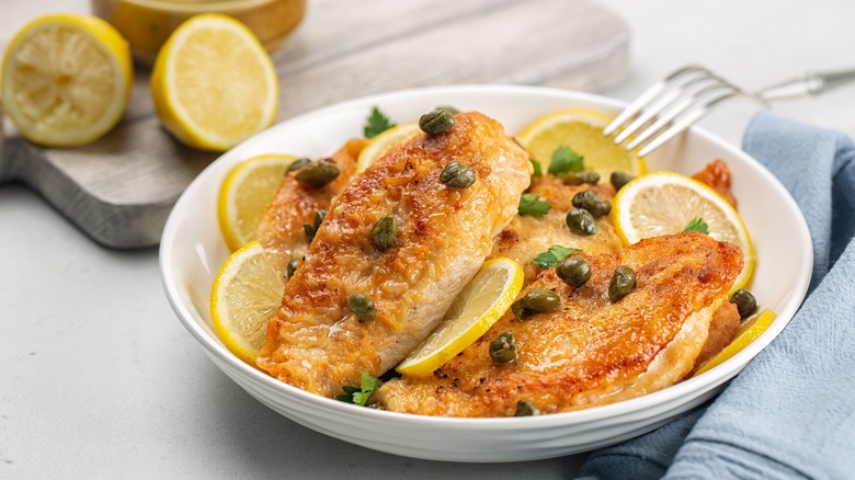 Dish of chicken piccata with lemons and capers