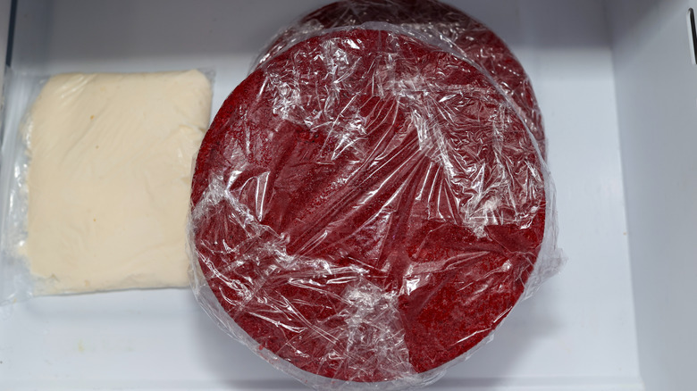 Red velvet cake wrapped and frozen in the freezer