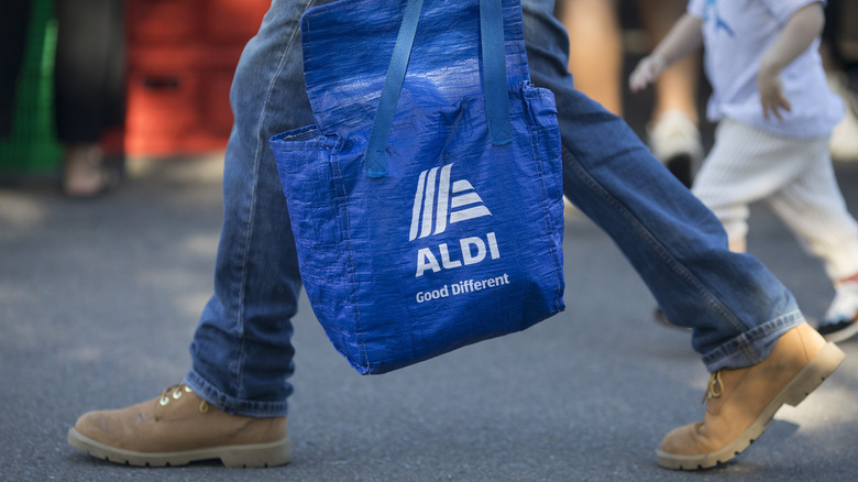 man carrying ALDI shopping bag