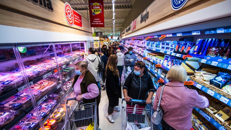 shoppers in Lidl store aisle