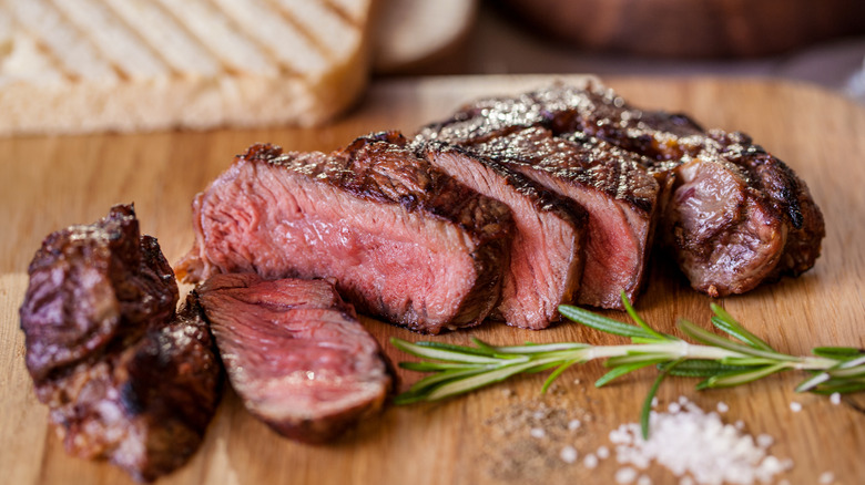 Sliced steak on cutting board