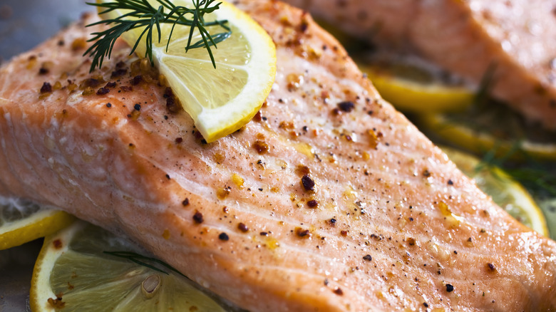 Salmon topped with lemon close up