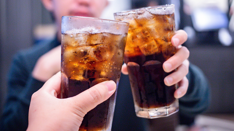 People toasting glasses of cola