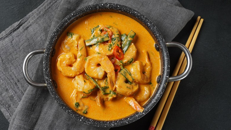 Yellow shrimp curry with chopsticks