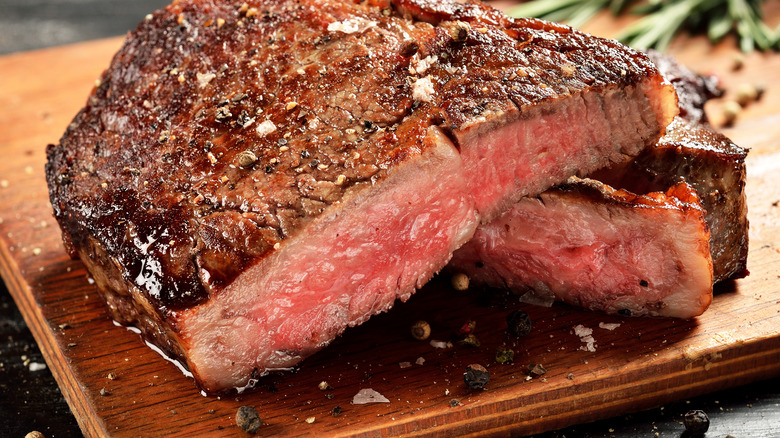 Ribeye steak on a cutting board with flaky salt