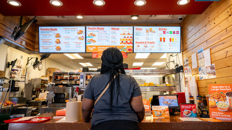 Woman ordering at Popeyes