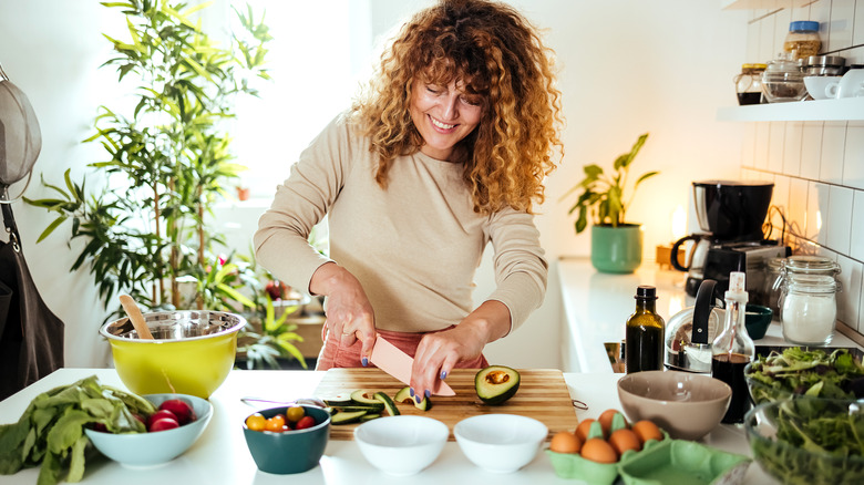 woman chopping avocados