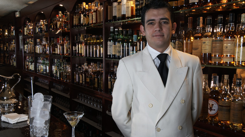 Bartender at bar with martini