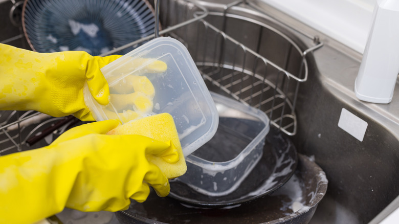Washing plastic food container in sink