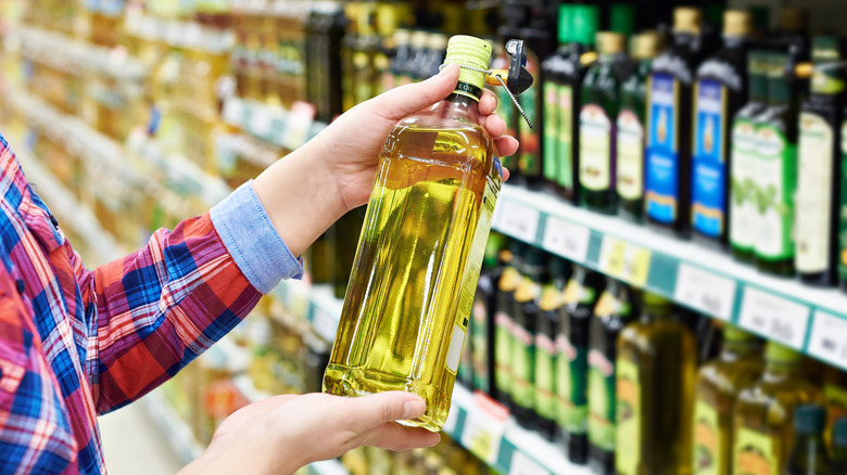 woman picking oil at store