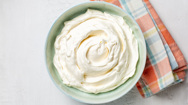 Creamy whipped ricotta cheese in bowl