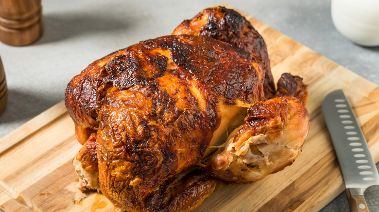 Rotisserie chicken on a wooden cutting board