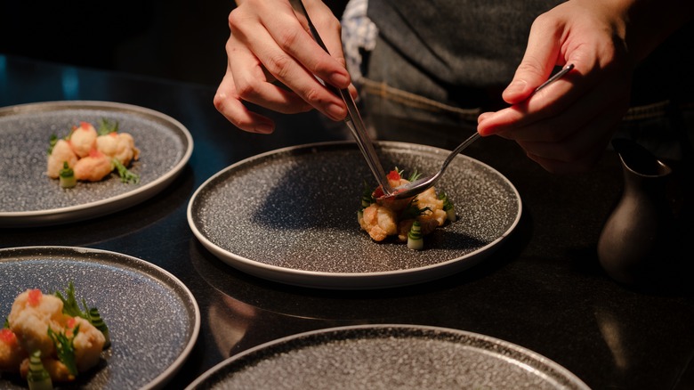 Chef preparing plated food