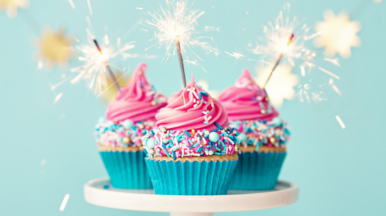 Pink cupcakes with lit sparklers