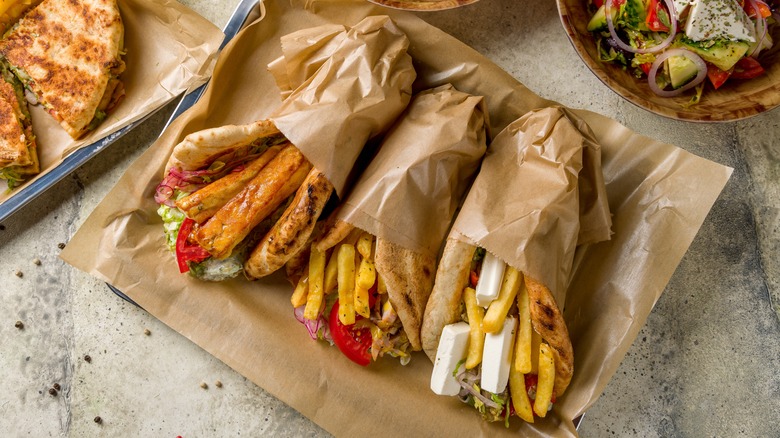 A variety of gyros on a tray