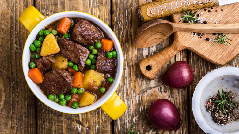 Beef stew with potatoes, carrots and greens.