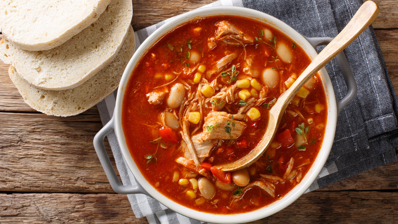 A hot bowl of traditional Brunswick stew with bread.