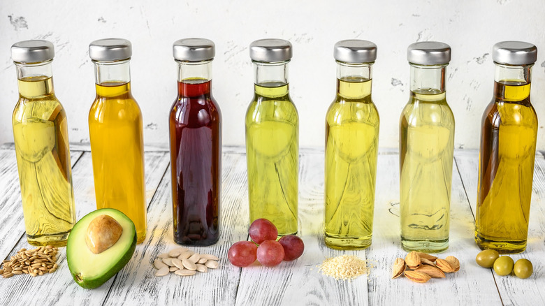 Different types of vegetable oils in glass bottles