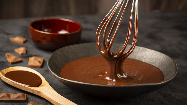 Chocolate sauce in bowl with whisk