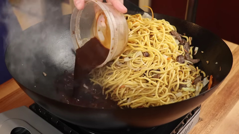 Sauce being added to noodles