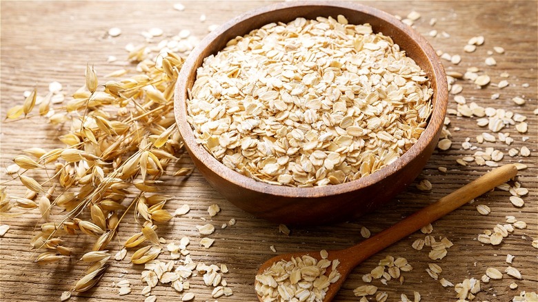 Raw oats in wooden bowl 