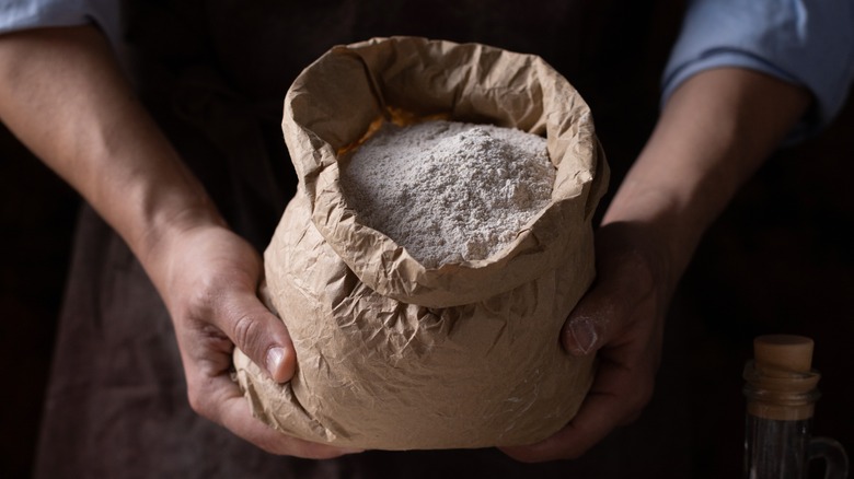 Person holding bag of flour