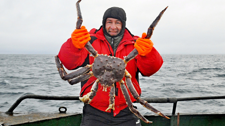 Fisherman holding red king crab