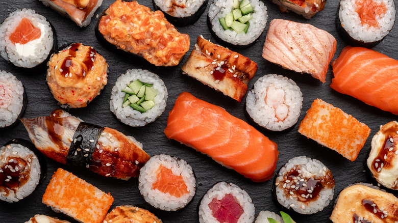 Variety of sushi and sashimi rolls