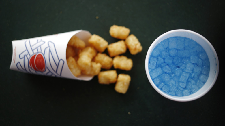 sonic tater tots next to cup of ocean water