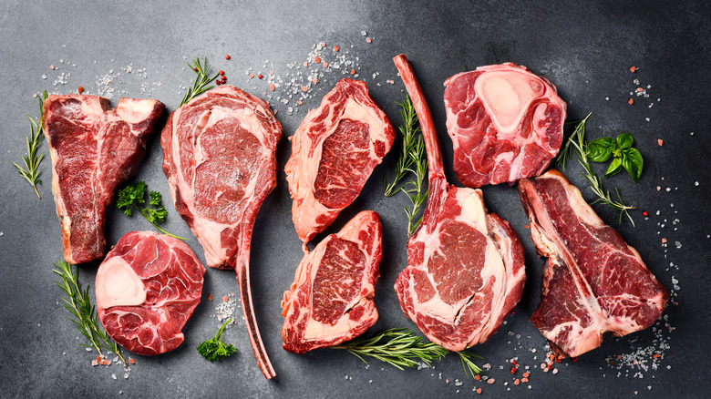 variety of steaks and herbs