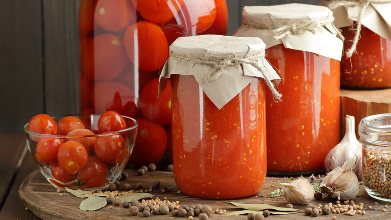 garlic, tomatoes and jars of tomato sauce