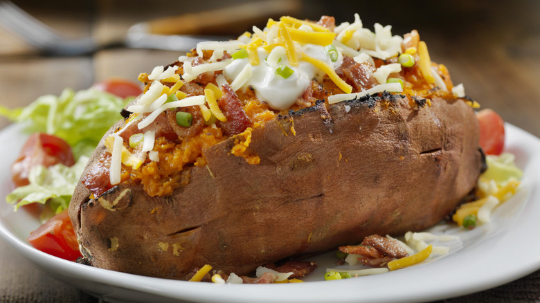 Loaded baked potato on plate 