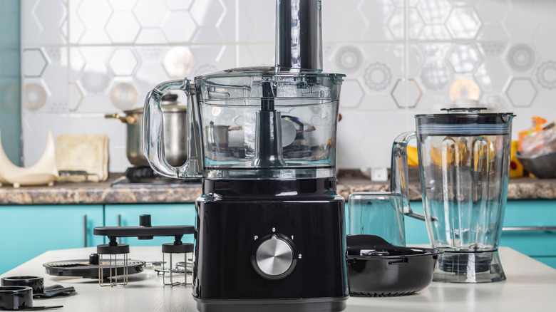 A blender and a food processor sitting on a countertop