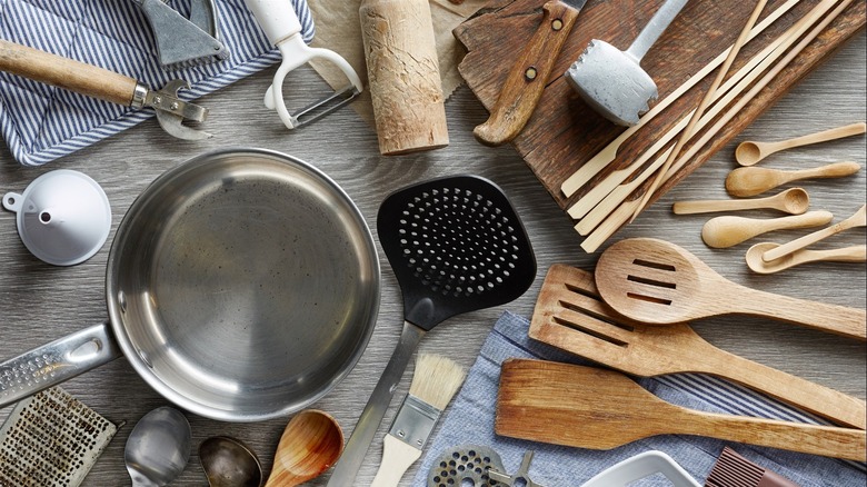 wooden cooking tools with pot and other kitchen tools