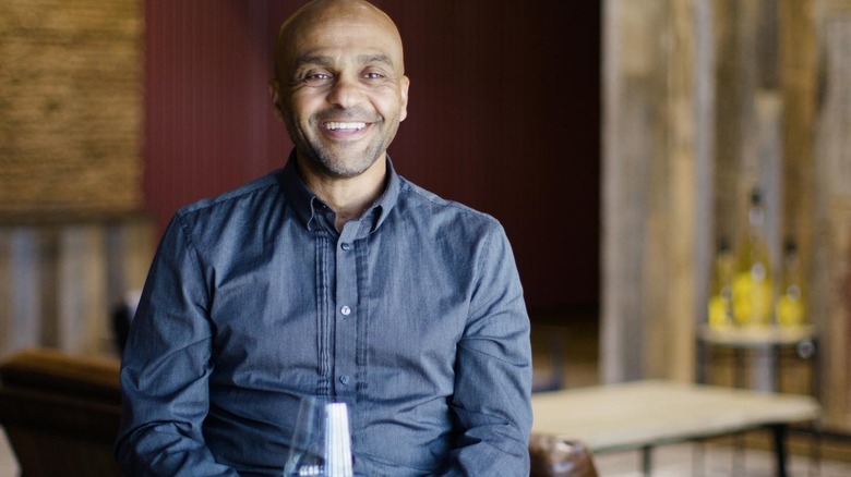 Ayele Solomon with a glass of Bee D'Vine wine