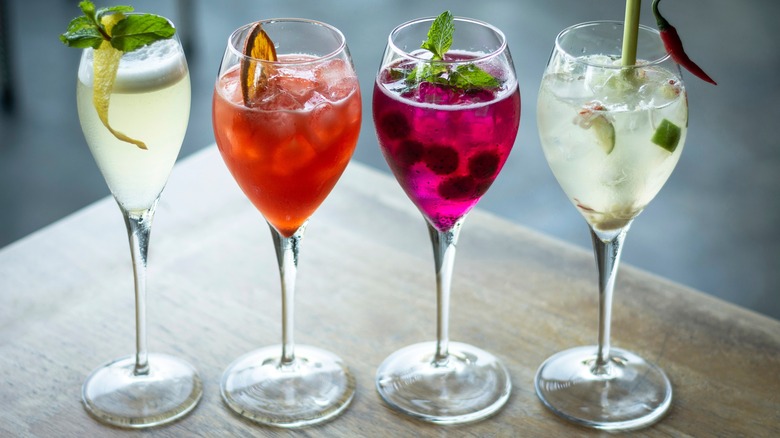 row of glasses with wine spritzers sitting on a table