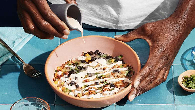 Someone putting together an Everytable preprepared meal