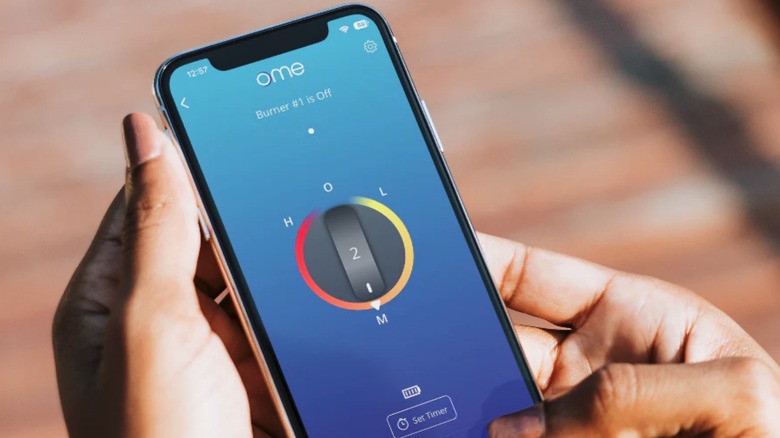 Hand holding phone with Ome app